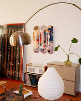 Living room with decorative elements including a lamp, vase, and a skate triptych by Wassily Kandinsky.