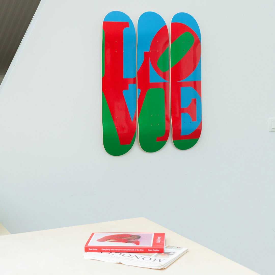 Robert Indiana's Love skateboard art by the skateroom on the wall of an office design space