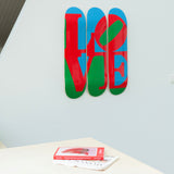 Robert Indiana's Love skateboard art by the skateroom on the wall of an office design space