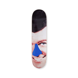 Close-up of a smiling face with a blue shape over the nose on a John Baldessari skateboard deck, produced by THE SKATEROOM.