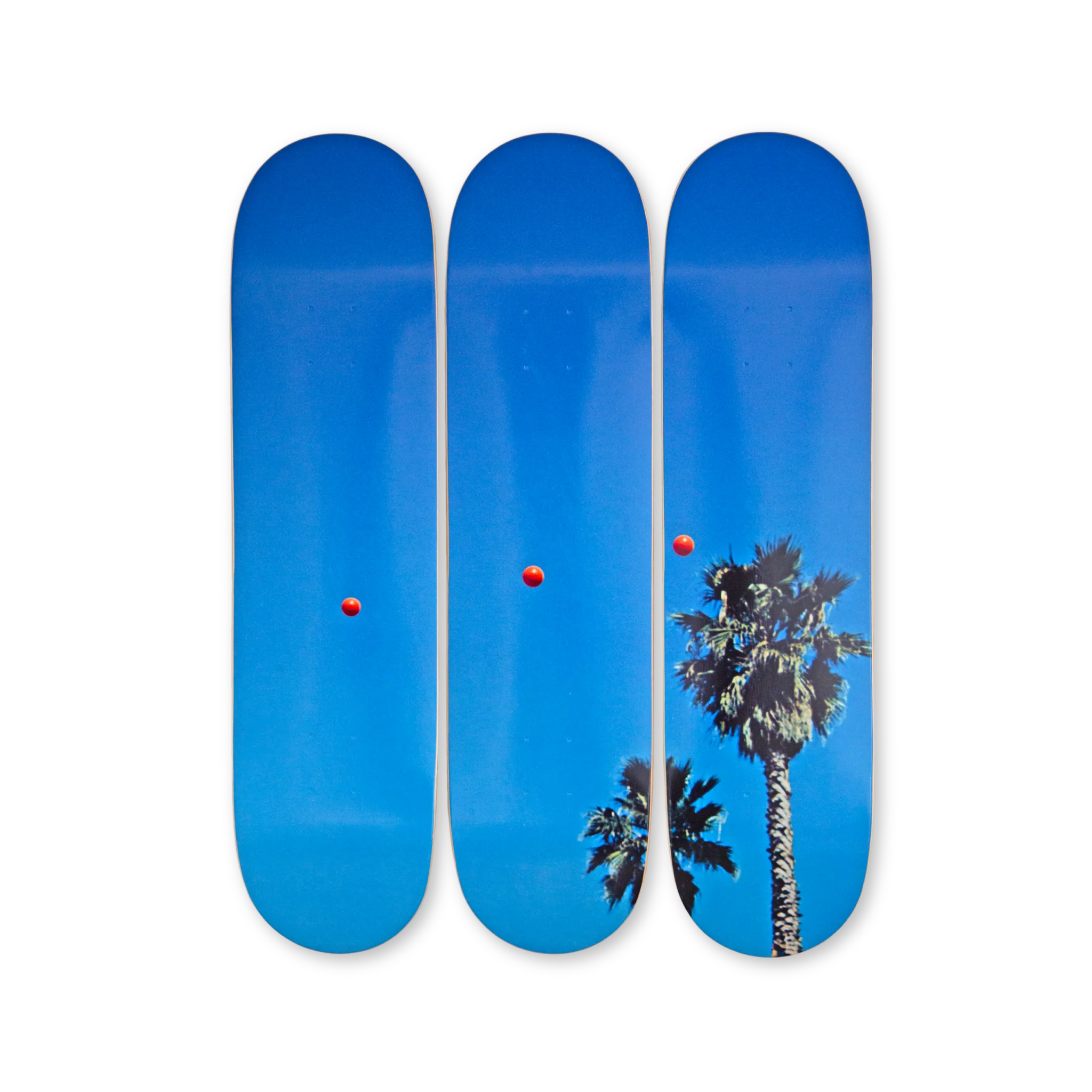 Baldessari triptych skateboard decks showing red balls in blue sky with palm trees, from THE SKATEROOM collection.