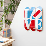 Robert Indiana's Great American Love skateboard art by the skateroom on the wall of an office