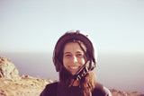 Girl with skateboard helmet posing for a portrait outside