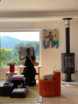 blogger yunji woman reading book in beautiful interior design room with Jean-Michel BASQUIAT skateboard hung on background wall