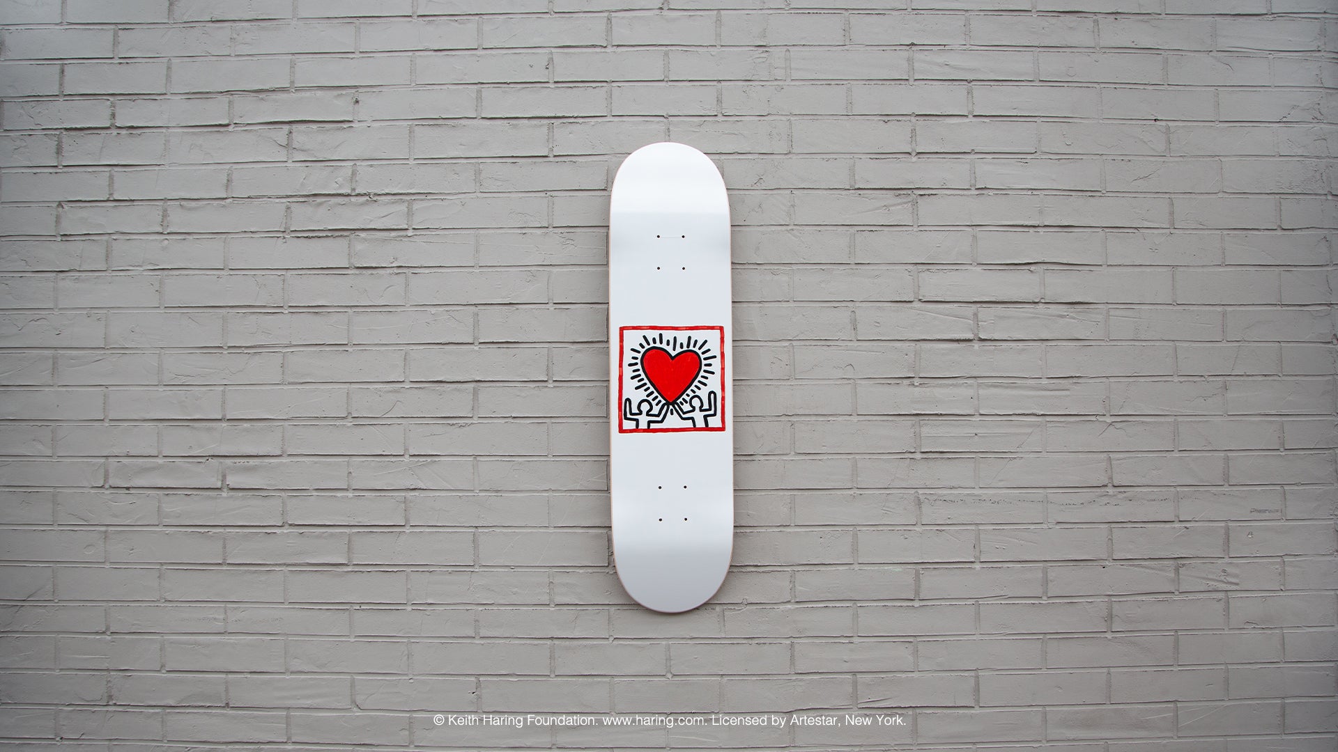 keith haring wall art on a skate deck
