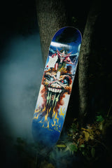 The Evil That Men Do skate deck by Iron Maiden in a spooky, foggy forest scenery.