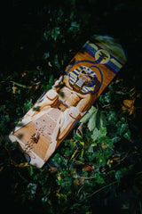 The Powerslave skate deck by Iron Maiden in a spooky, foggy forest scenery.