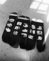 Set of five limited-edition skate decks from Jim Jarmusch's 'TV Photos' collection, featuring black-and-white stills from vintage television screens. Photographed in natural light on a textured concrete floor.
