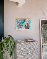 Framed Reality Dropout art print by Little Thunder on a wall above a patterned dresser