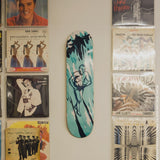 Raymond Pettibon's No Title (You have clear) 1990 skateboard art by the skateroom on a wall between vinyl covers
