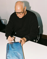 Belgian artist Luc Tuymans signing a skate deck.