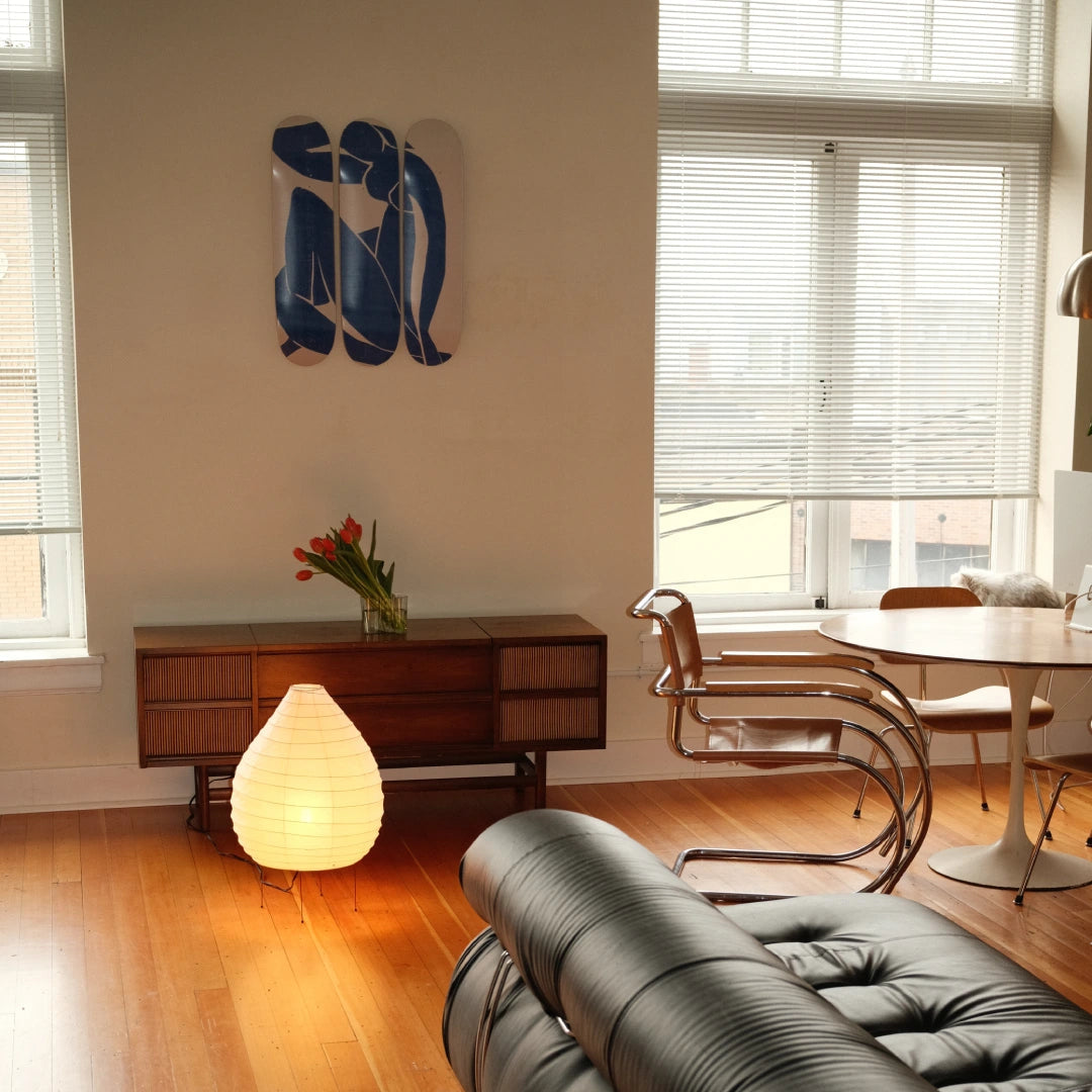 Henri Matisse 'Blue Nude' triptych skate deck elegantly displayed on a living room wall, blending seamlessly with mid-century modern furniture and soft natural light.