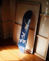 Henri Matisse 'Jazz' skate deck leaning against framed canvases, illuminated by soft natural light, emphasizing its artistic elegance and versatility as both art and object.