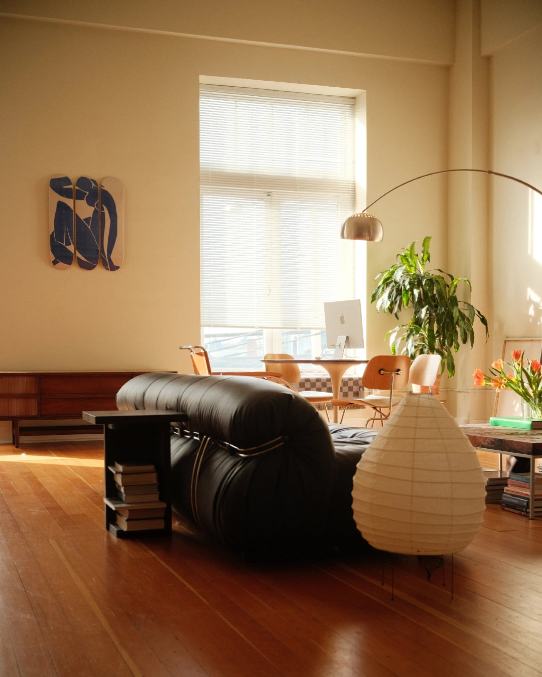 Henri Matisse 'Blue Nude' triptych skate deck elegantly displayed on a living room wall, blending seamlessly with mid-century modern furniture and soft natural light.