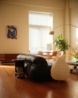 Henri Matisse 'Blue Nude' triptych skate deck elegantly displayed on a living room wall, blending seamlessly with mid-century modern furniture and soft natural light.