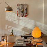 Close-up of a stylish living room showcasing a Jean-Michel Basquiat skateboard triptych by THE SKATEROOM, a modern coffee table with art books, a turntable setup, and soft natural light creating a cozy and artistic atmosphere.