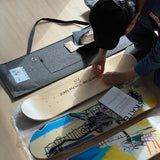 someone preparing easyfix wall mounts to hang his Basquiat skate triptych