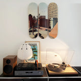 Turntable setup on a USM Haller sideboard with speakers and City Roofs skate triptych by Edward Hopper on a white wall