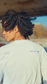 Model wearing the Thomas Lélu x THE SKATEROOM long sleeve t-shirt, view of the back print.
