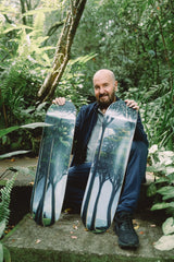 Tomas Sanchez holding two skateboard decks limited editions in a jungle setting