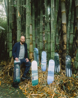Artist Tomas Sanchez with his THE SKATEROOM limited skate decks editions posing in front of bamboos