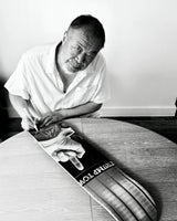 Ai weiwei signing a skate deck by the skateroom