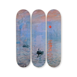 Three skateboard decks the artwork Impression Soleil Levant by Claude Monet, featuring boats and a red sun.