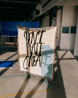 Woven blanket with 'Don't Hate Create' artwork by artist David Carson.