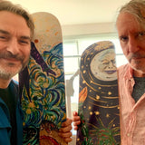 Artists Marcel Dzama and Raymond Pettibon holding their collaborative skate deck editions featuring surreal and expressive artwork. Dzama’s fluid, dreamlike figures blend with Pettibon’s bold, narrative-driven imagery, bringing their artistic fusion to skateboard decks in this limited-edition collection with THE SKATEROOM.