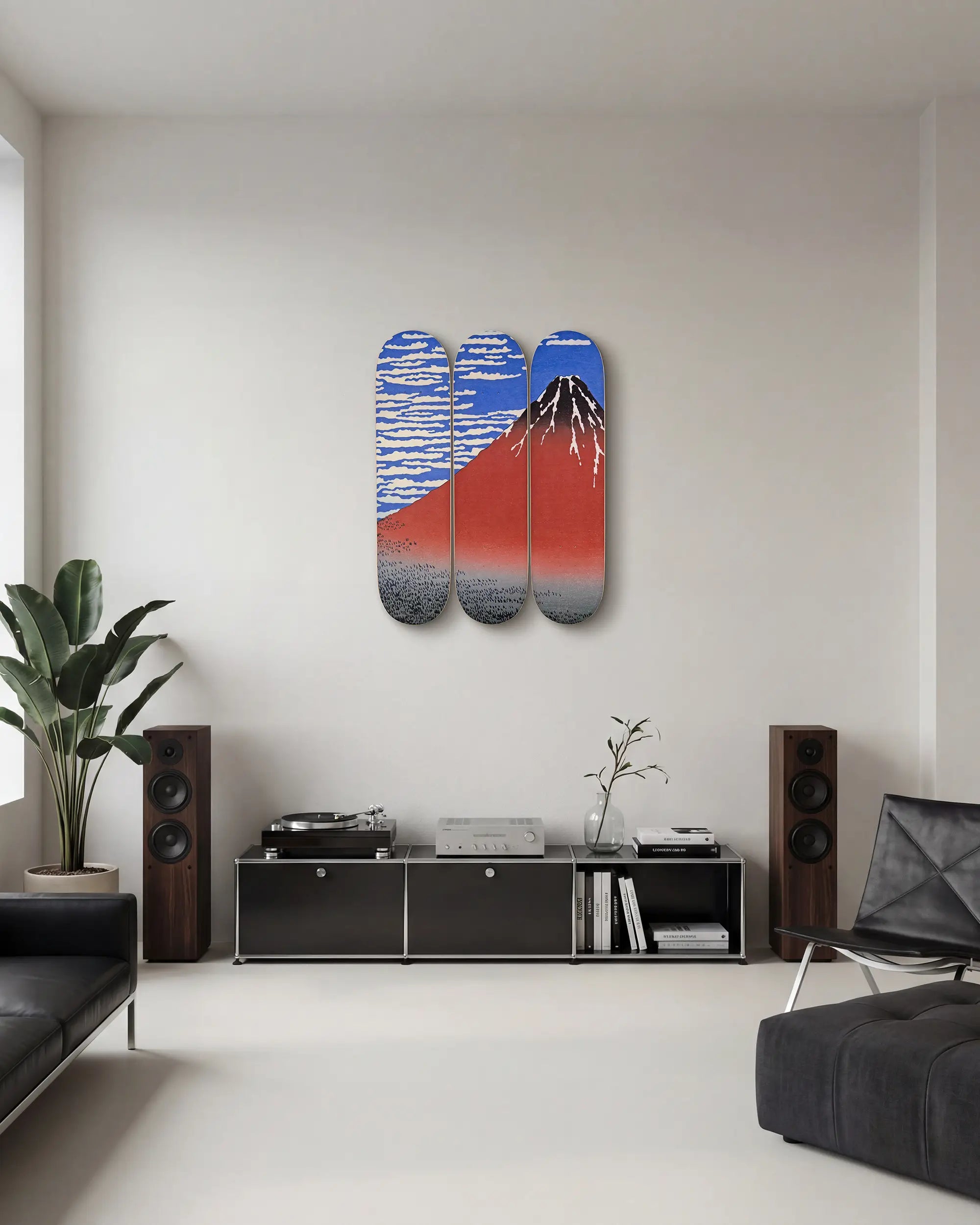 Three colorful skateboard decks with the Red Fuji artwork by Hokusai, mounted on a wall in a modern, minimalist living room.