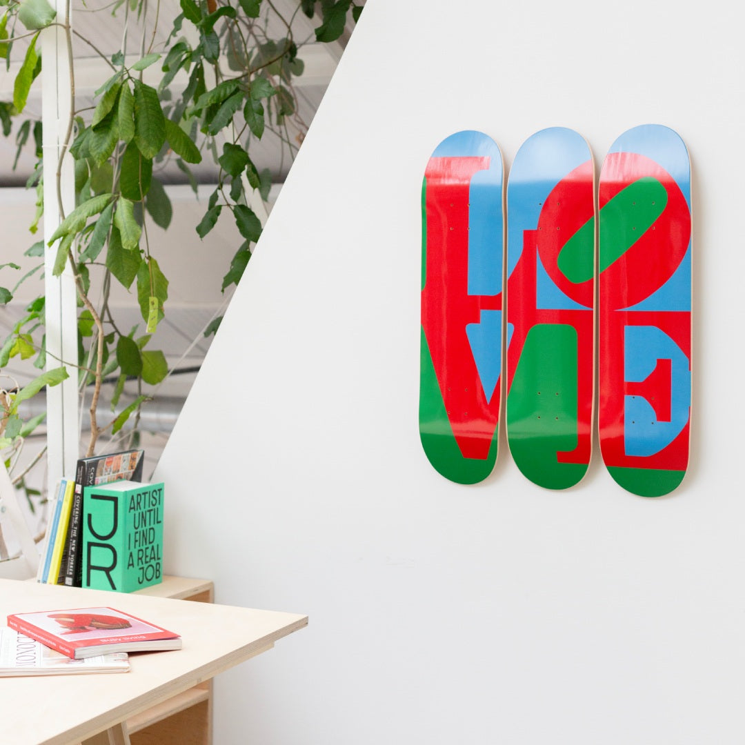 Robert Indiana's Love skateboard art by the skateroom on the wall of an office design space
