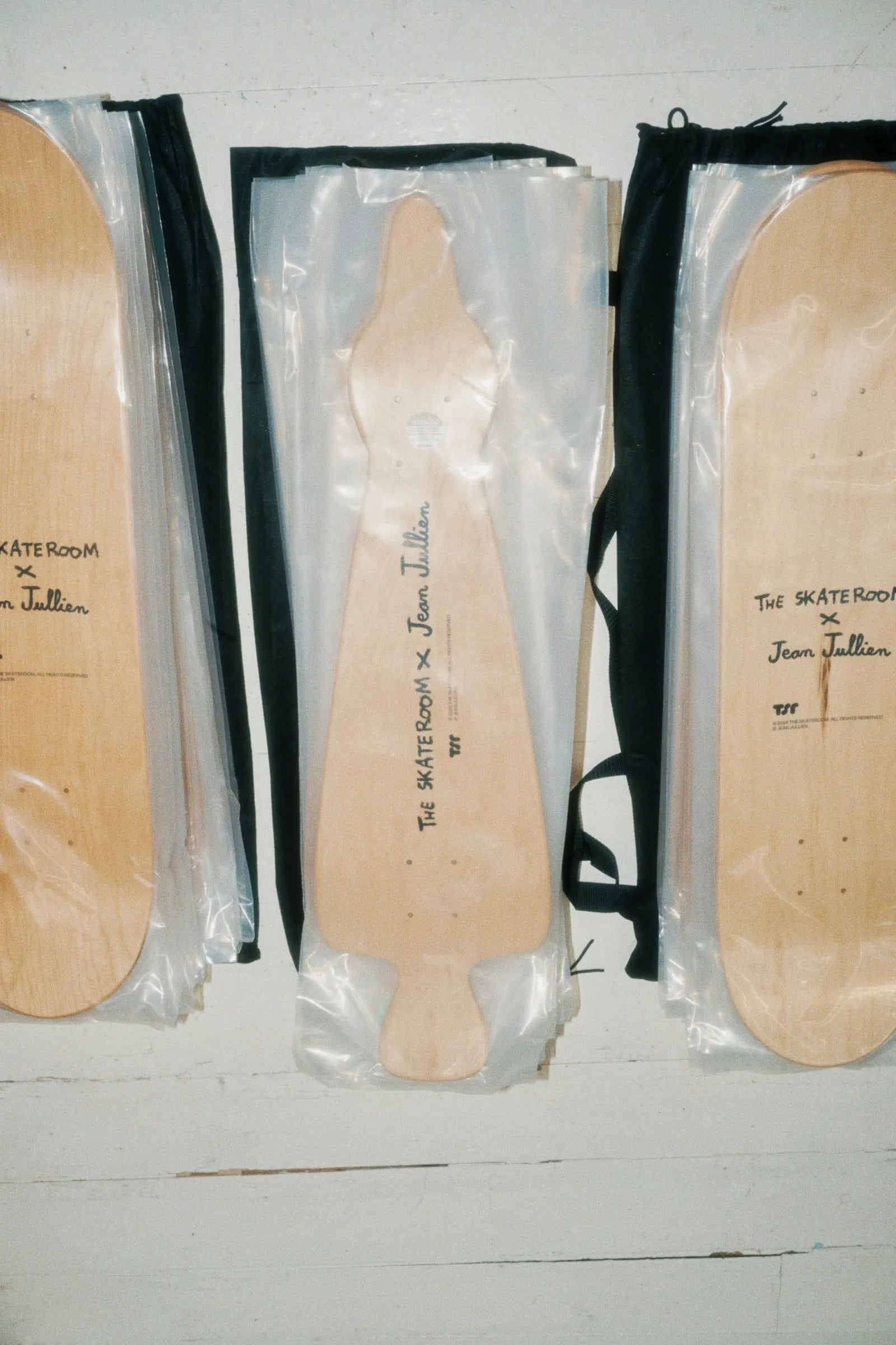 Jean Jullien collection of art skateboards by The Skateroom arranged together, lifestyle overhead shot showing full range