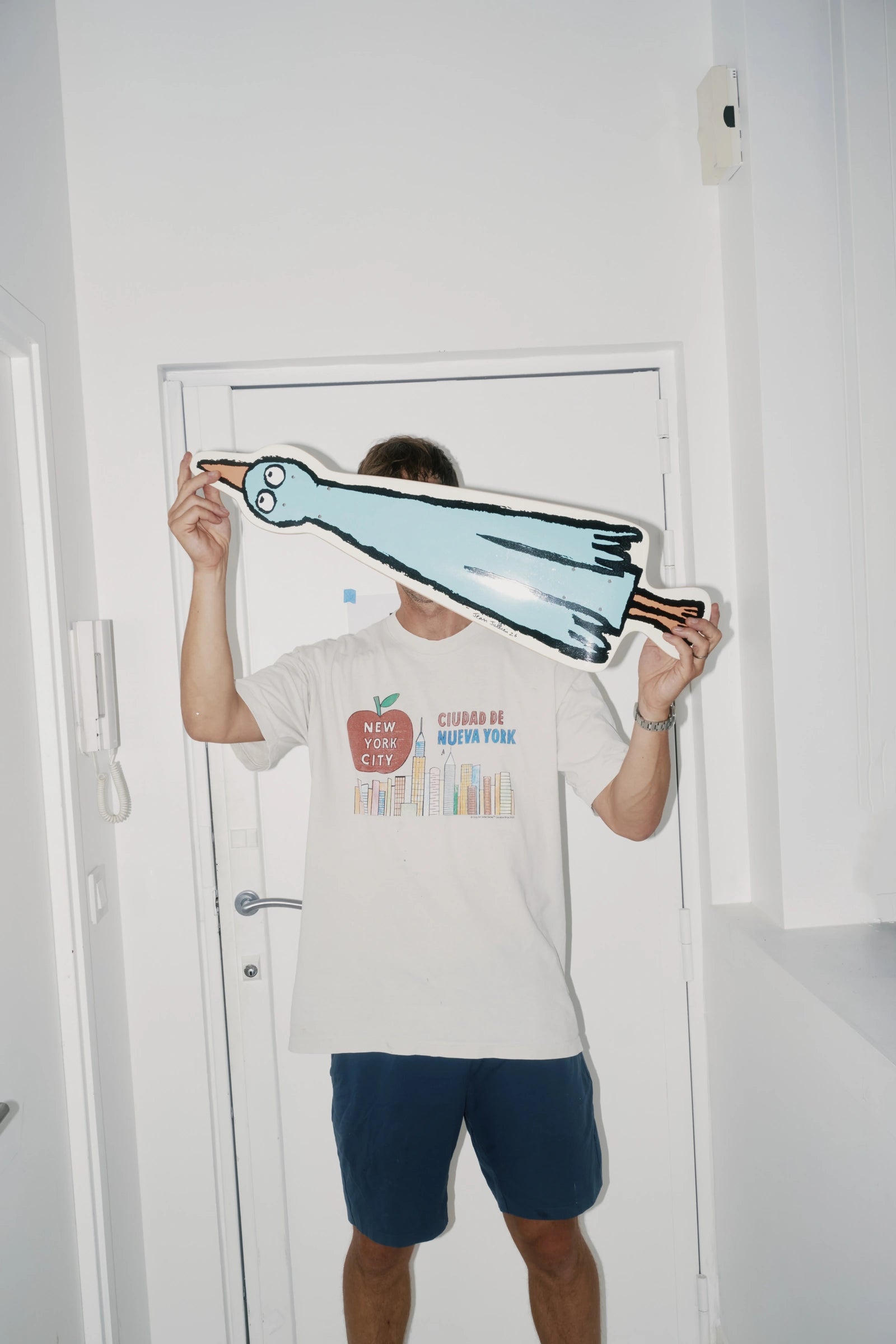 Jean Jullien holding a Birdboard art skateboard by The Skateroom, lifestyle editorial shot