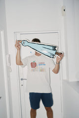 Jean Jullien holding a Birdboard art skateboard by The Skateroom, lifestyle editorial shot
