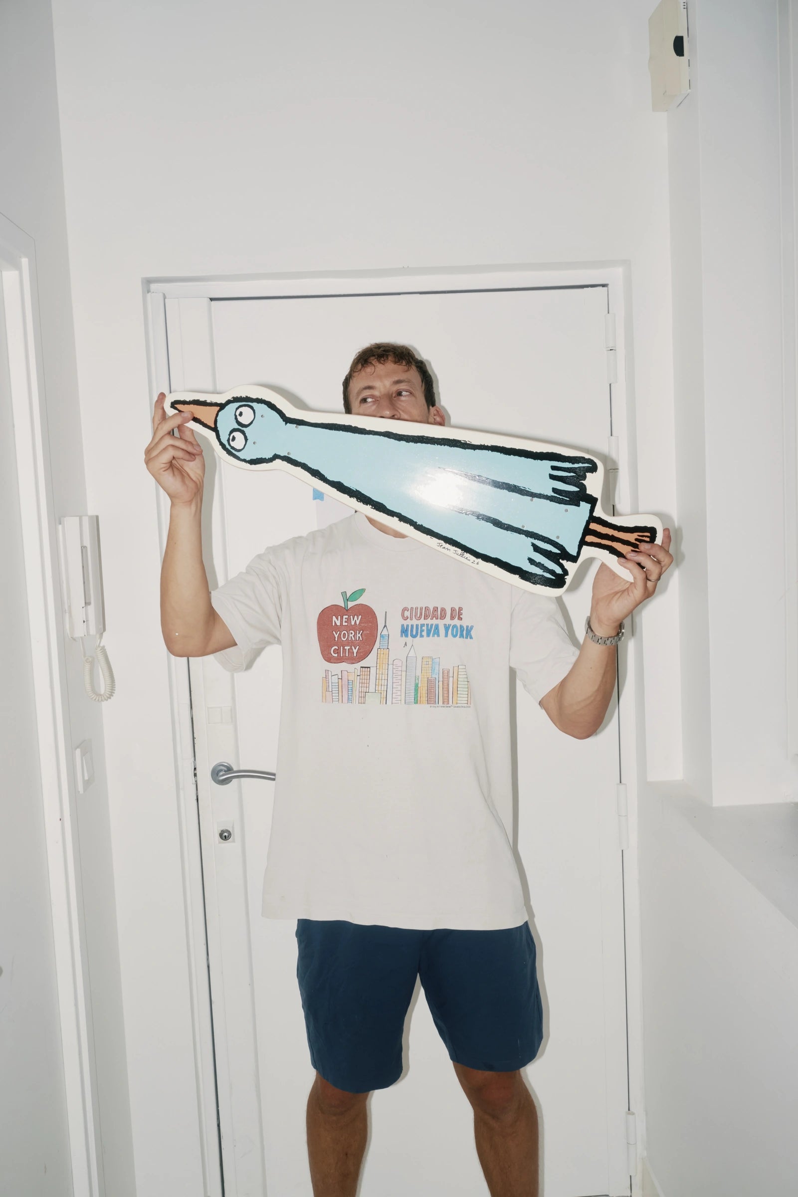 Jean Jullien hand-signing Birdboard art skateboard for The Skateroom — each hand-signed edition individually signed by the artist
