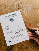 Little Thunder hand-signing a THE SKATEROOM certificate of authenticity