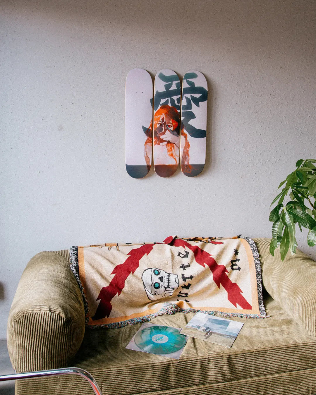 Little Thunder Love skateboard triptych displayed on a living room wall above a sofa