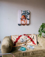 Little Thunder Love skateboard triptych displayed on a living room wall above a sofa