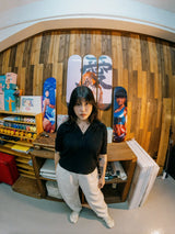 Hong Kong artist Little Thunder standing among her THE SKATEROOM skateboard editions