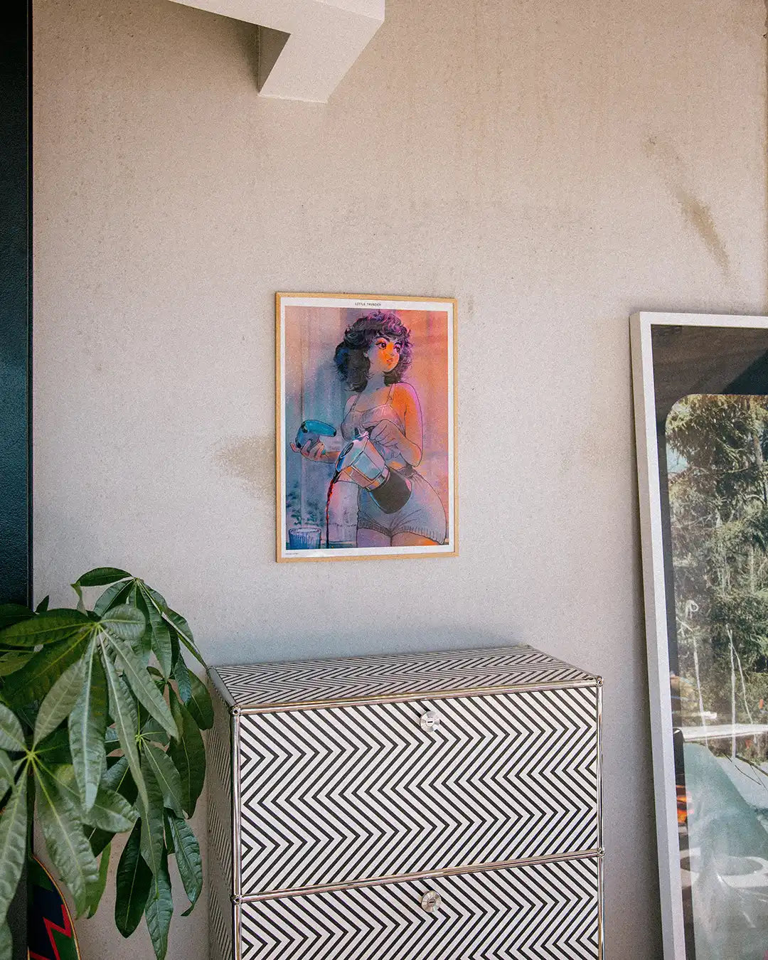 Framed Whirlwind art print by Little Thunder hanging above a dresser in a bright interior