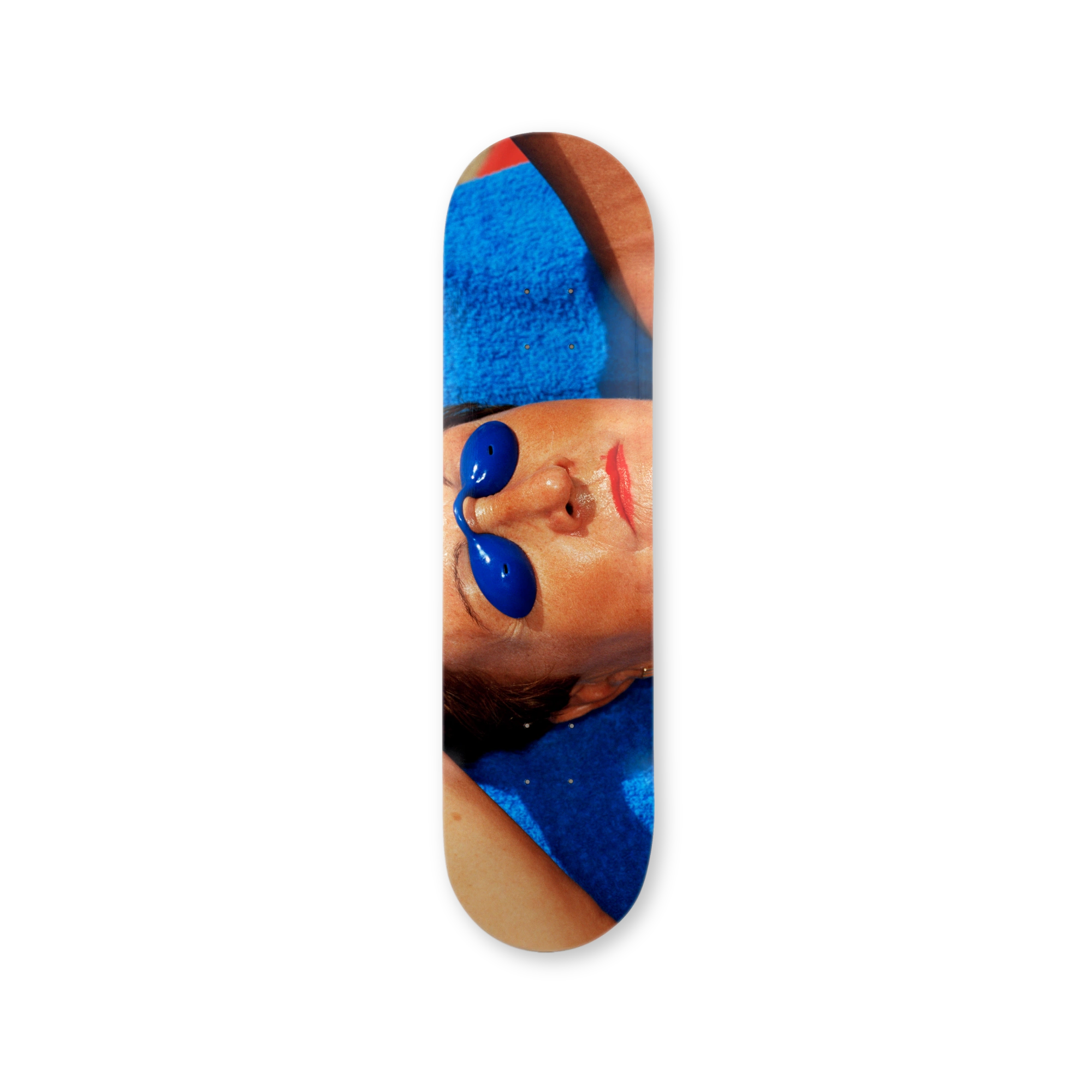 Skateboard deck with a photography by Martin Parr of a person wearing goggles in the sun.