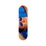 Skateboard deck with a photography by Martin Parr of a person wearing goggles in the sun.