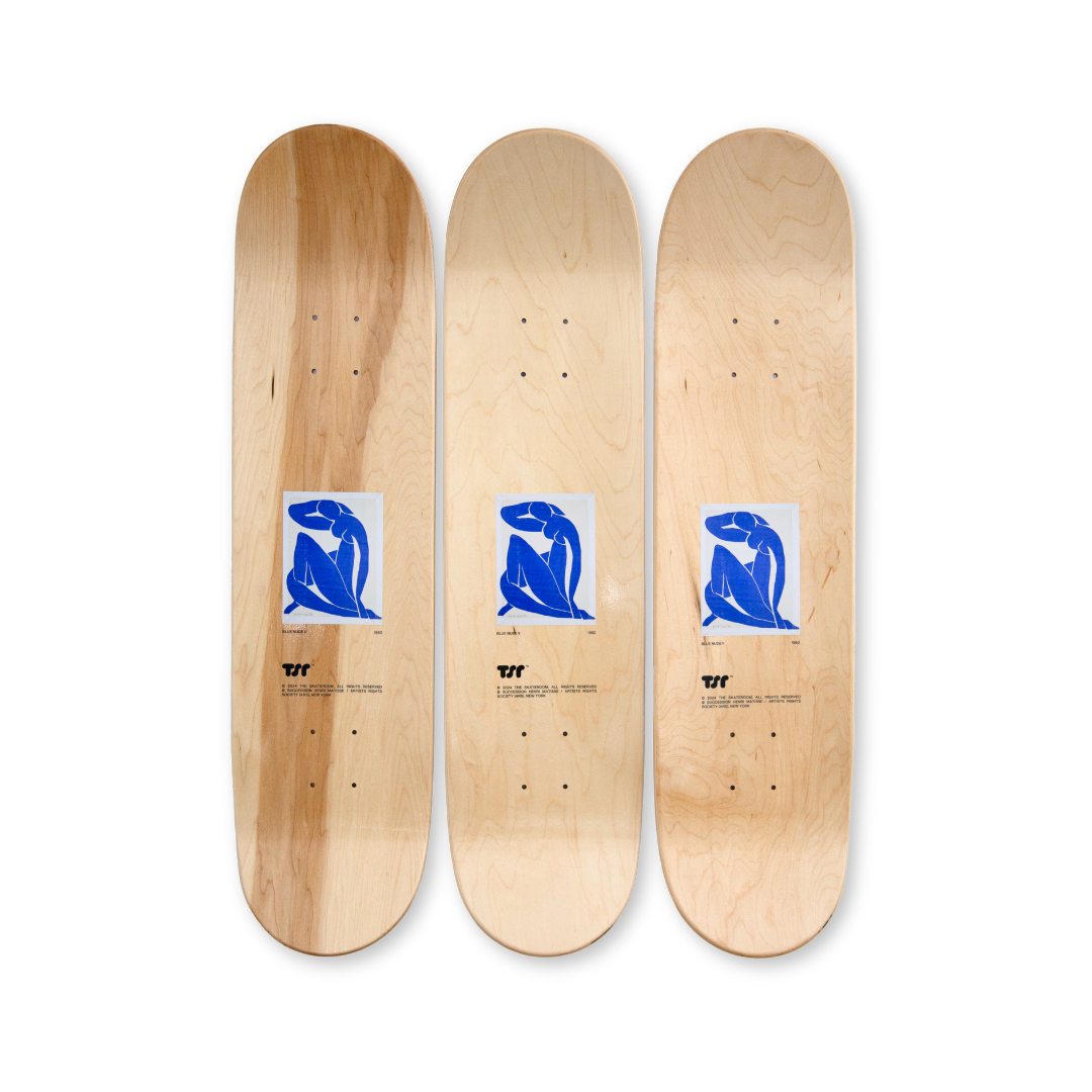 Top view of the Henri Matisse 'Blue Nude' skate decks set, featuring a minimalist natural wood finish with a small, vibrant print of the iconic artwork at its center.