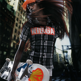 Model posing with MOTO deck by Mowalola and THE SKATEROOM, styled in Mowalola clothing.
