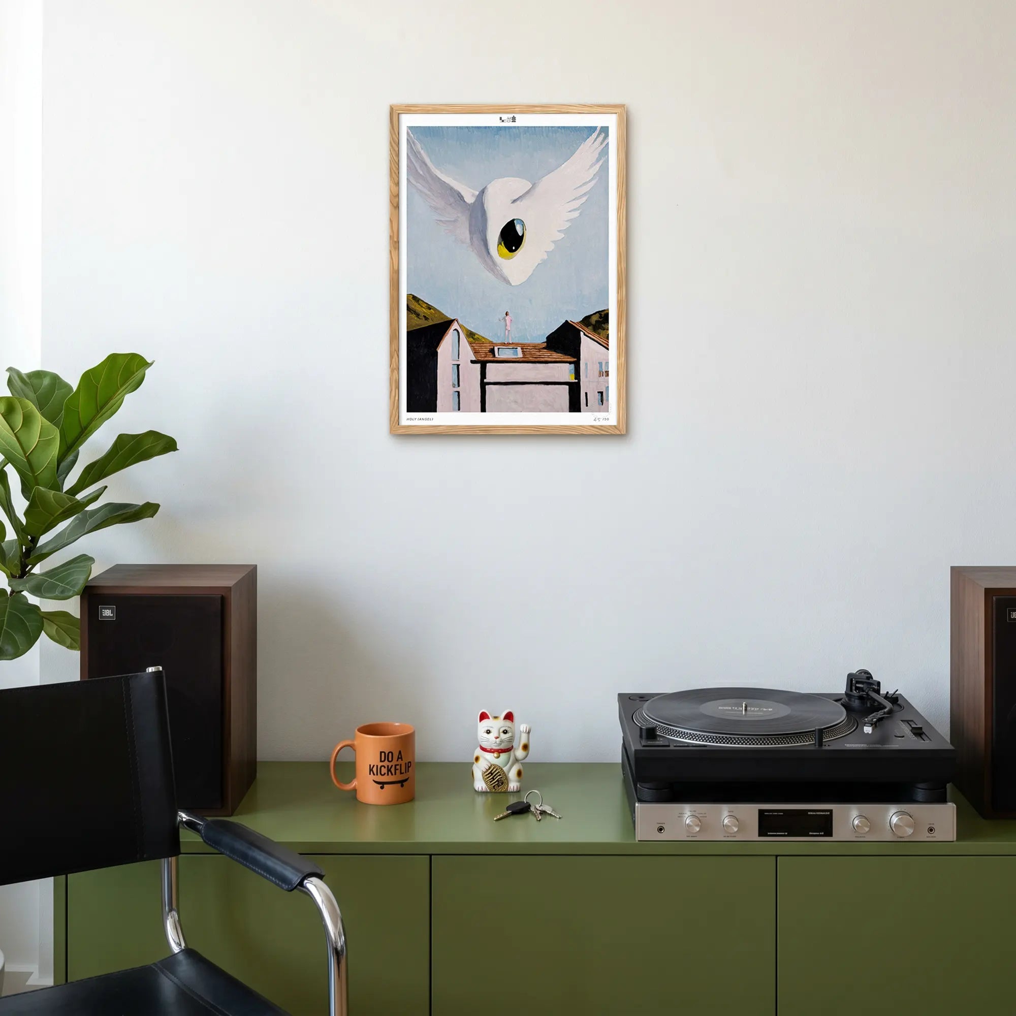 Holy (Angel) print by Sangho Noh displayed on a wall above a minimal designer console in a contemporary interior