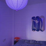 Henri Matisse Blue Nude edition by THE SKATEROOM displayed on a wall above a bed in a stylish bedroom setting.