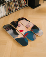 Set of three decorative skate decks featuring an iconic scene from Disney movie Snow White, lying on a wooden floor.